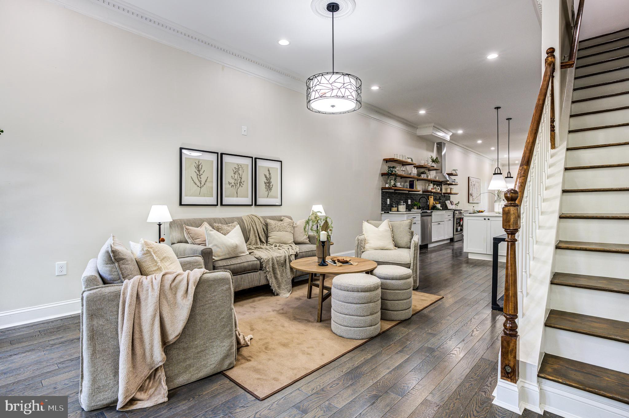 a living room with furniture potted plant and a chandelier