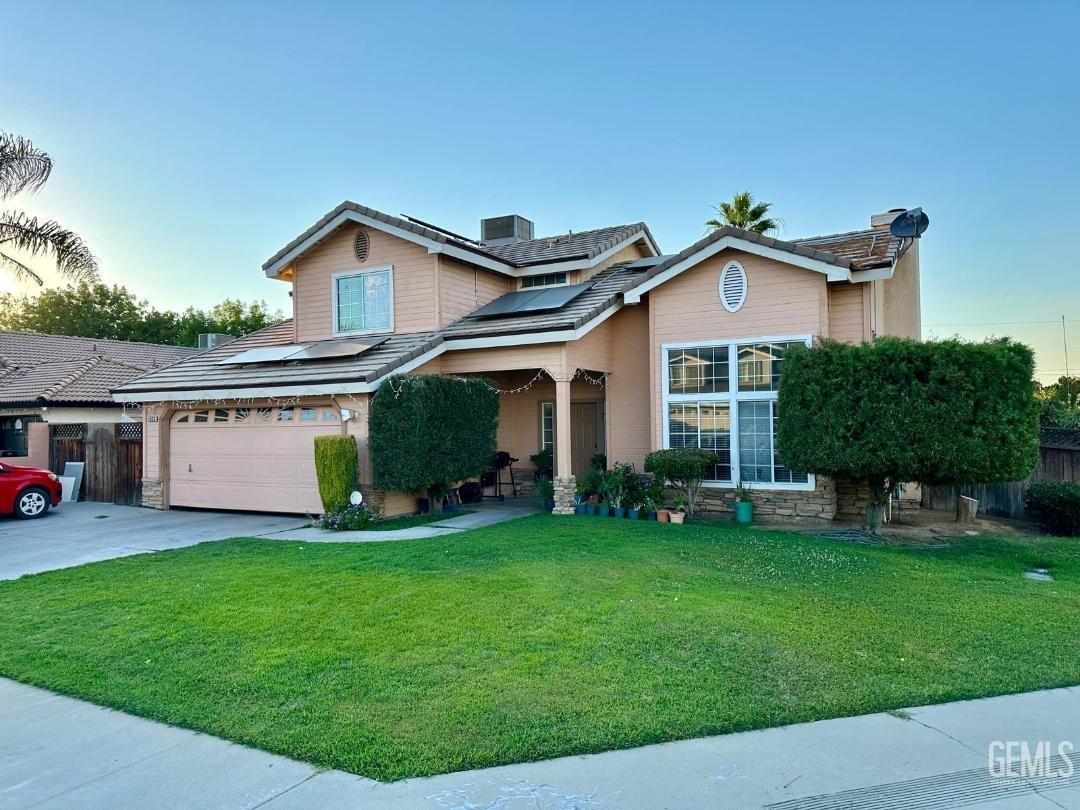 a front view of house with yard and green space