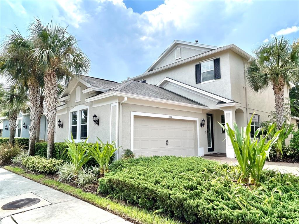 a front view of a house with a garden