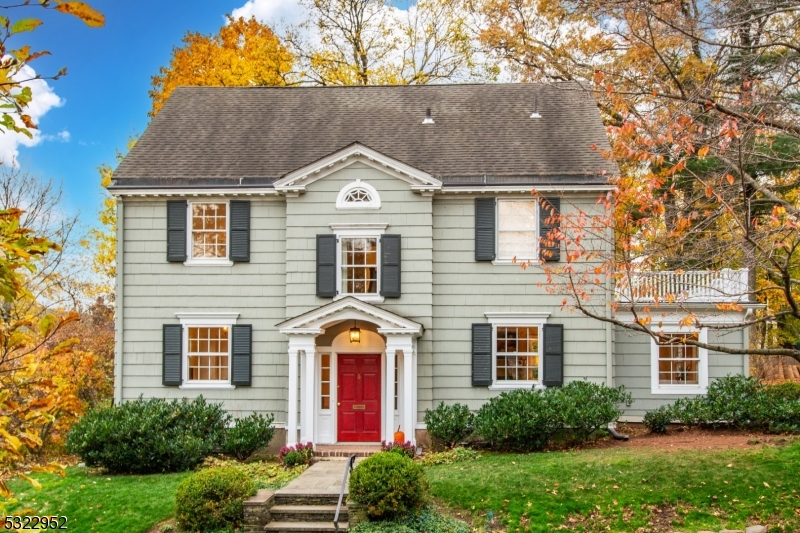 a front view of house with yard and trees around