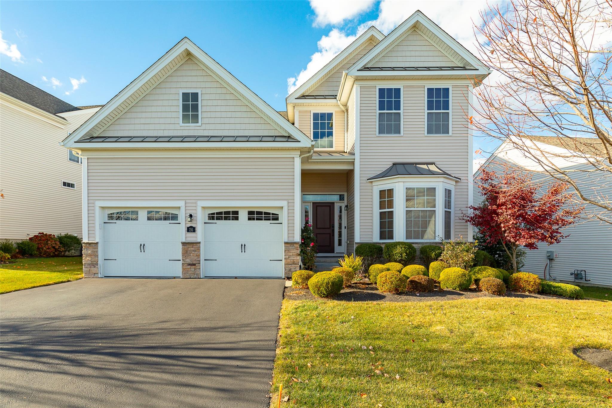 View of front of home featuring a front yard and a garage