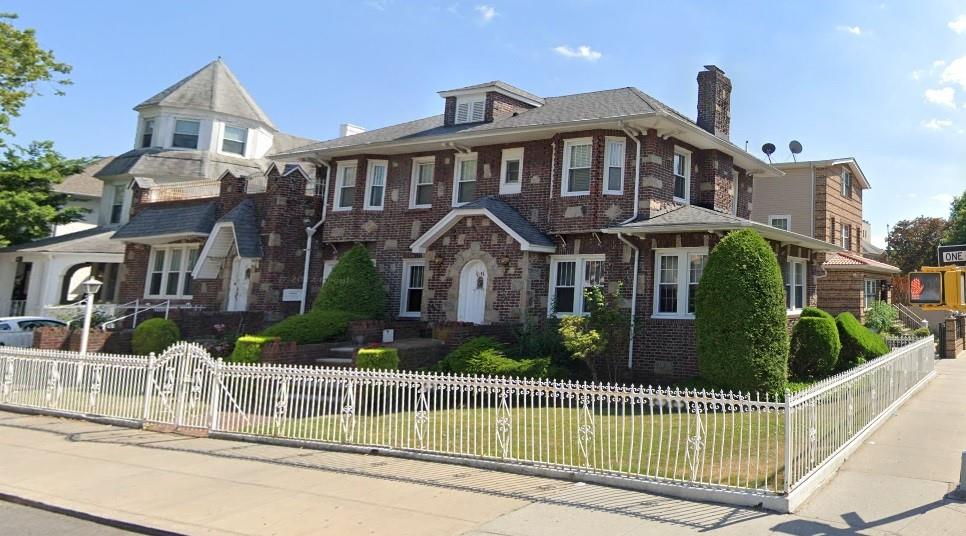 a front view of a house with a garden and plants