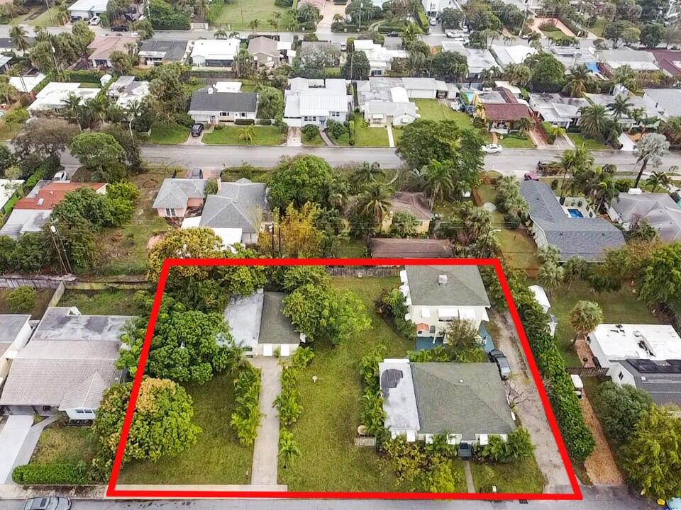 an aerial view of residential houses with outdoor space and street view