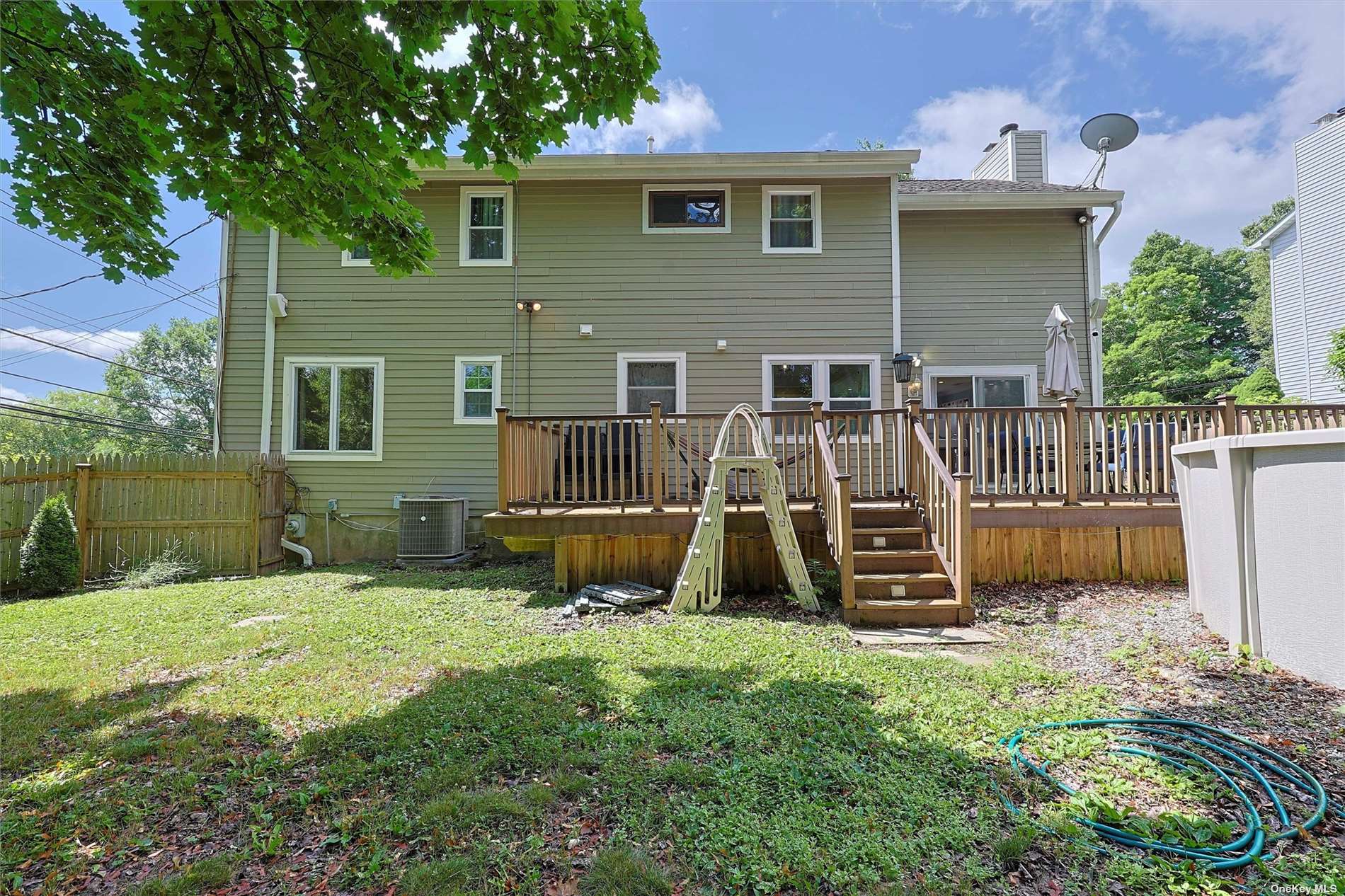 a view of backyard with a garden and deck