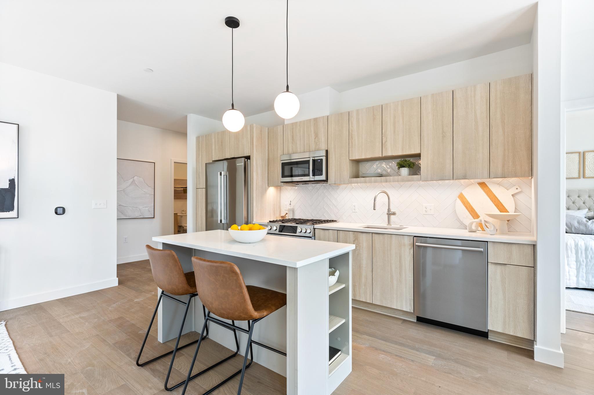 a kitchen with a stove a sink a dining table and chairs