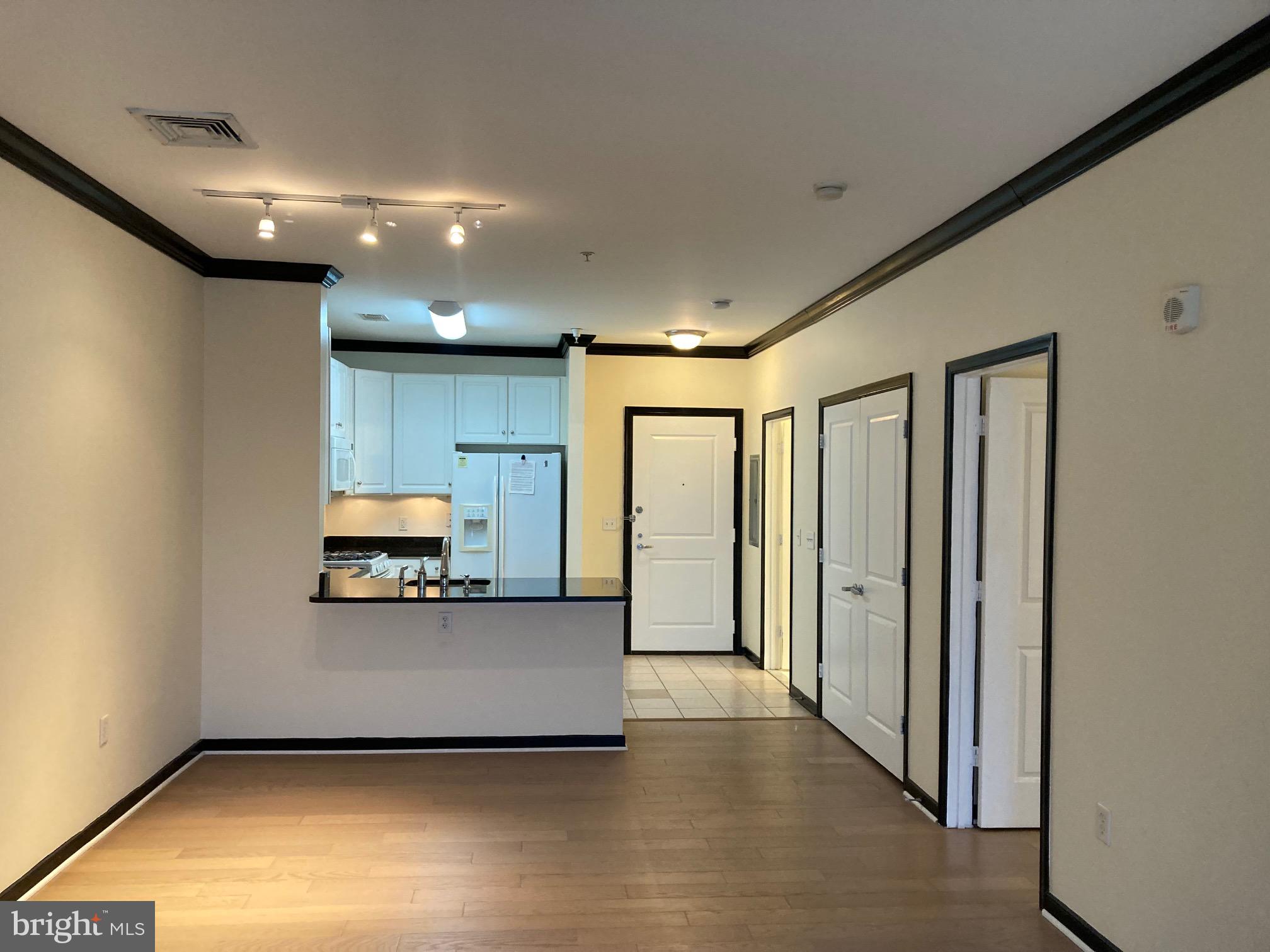 a view of a hallway with wooden floor