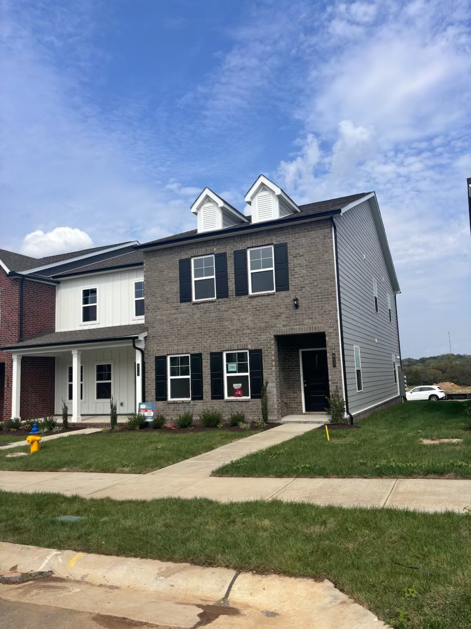 a front view of a house with a yard