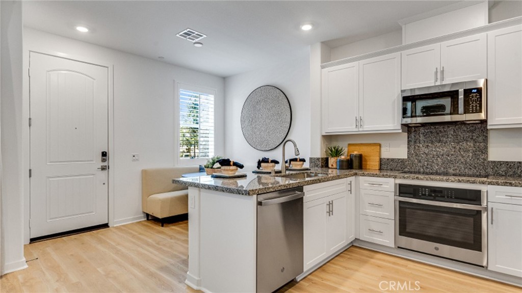 a view of a kitchen with a sink and a microwave