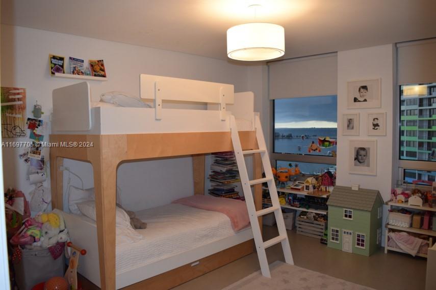 a bedroom with a bed and a book shelf