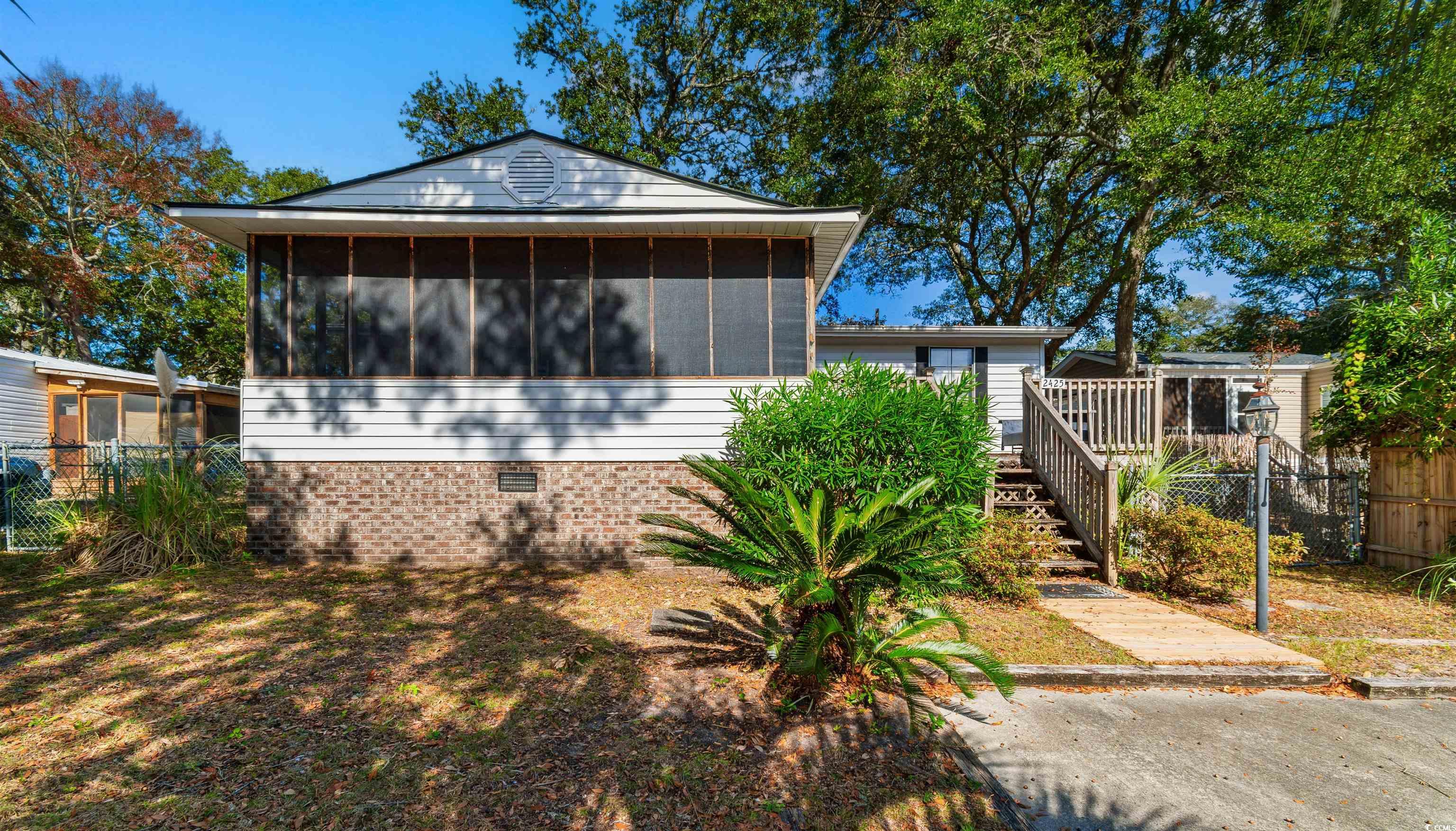 View of front of house featuring a sunroom