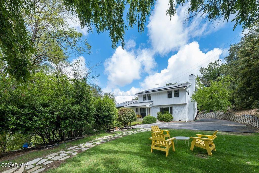 a white house with a small yard and a swimming pool