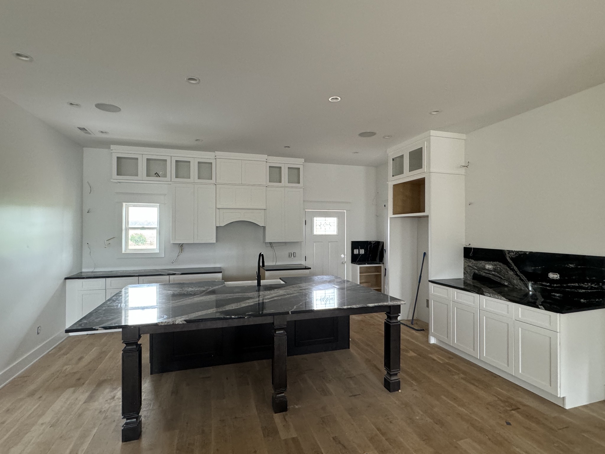 a kitchen with kitchen island stainless steel appliances a sink and stove