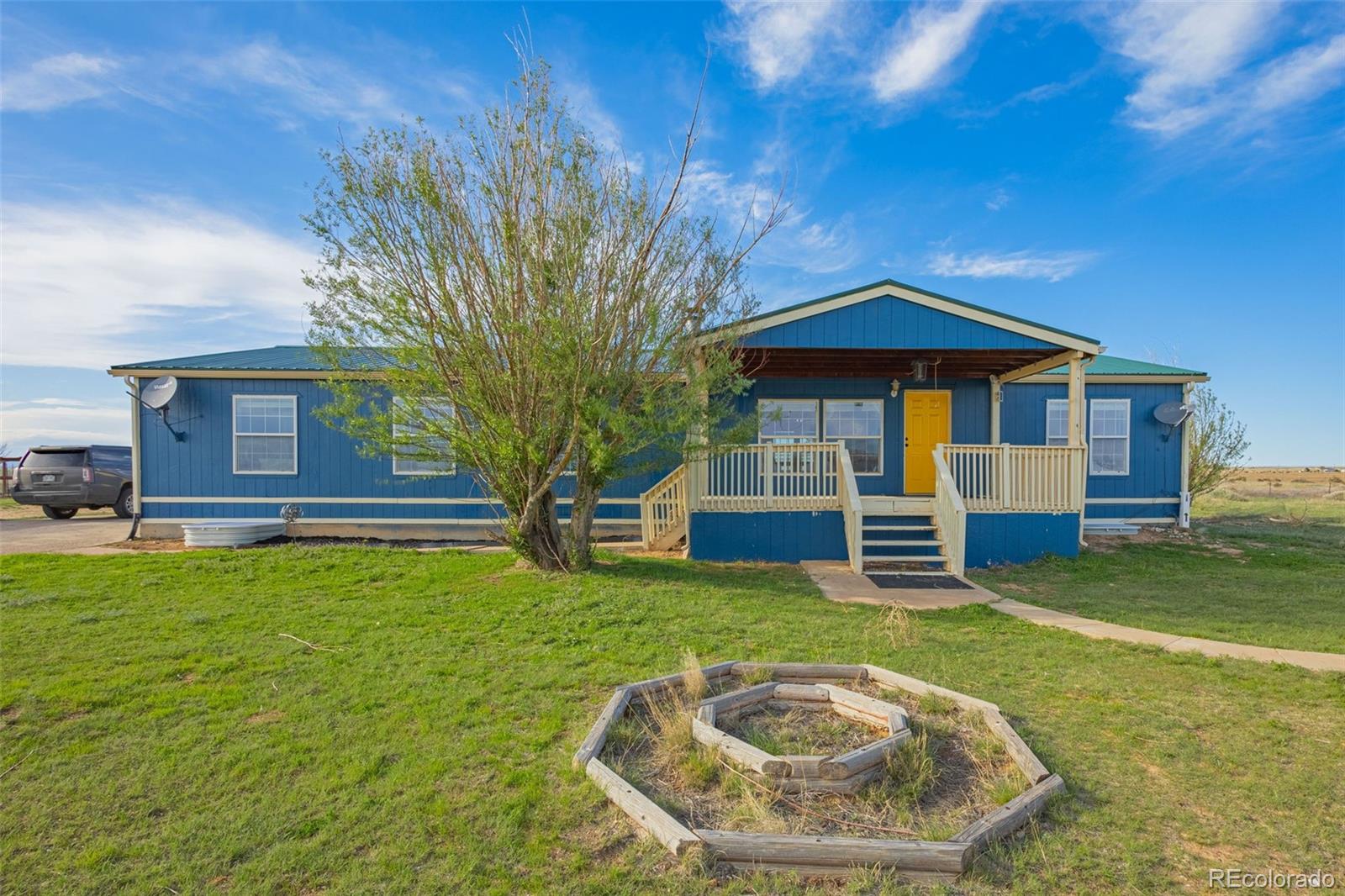 a view of a house with backyard porch and sitting area