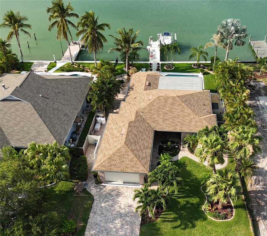 an aerial view of a house with a yard pool patio and outdoor seating