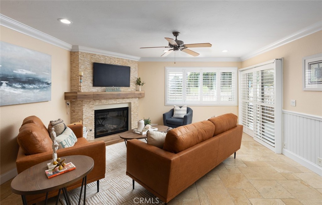 a living room with furniture a flat screen tv and a fireplace