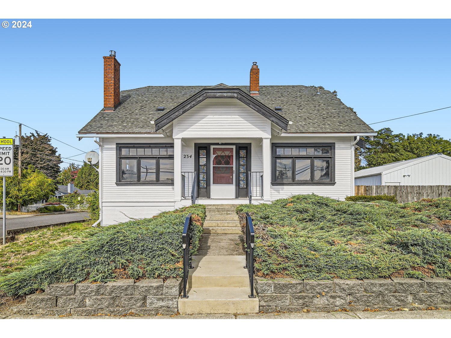 a front view of a house with garden