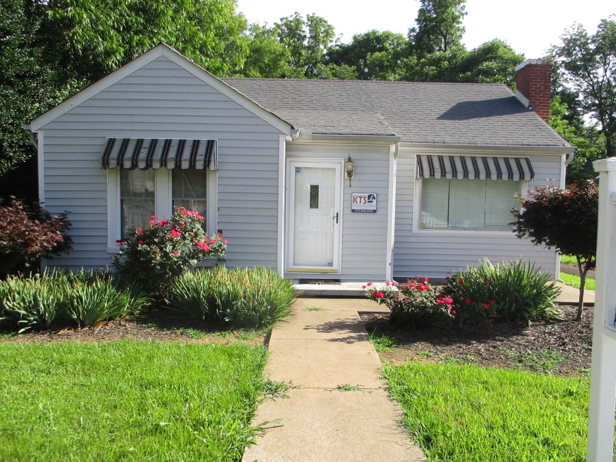 a house with flowers in front of it