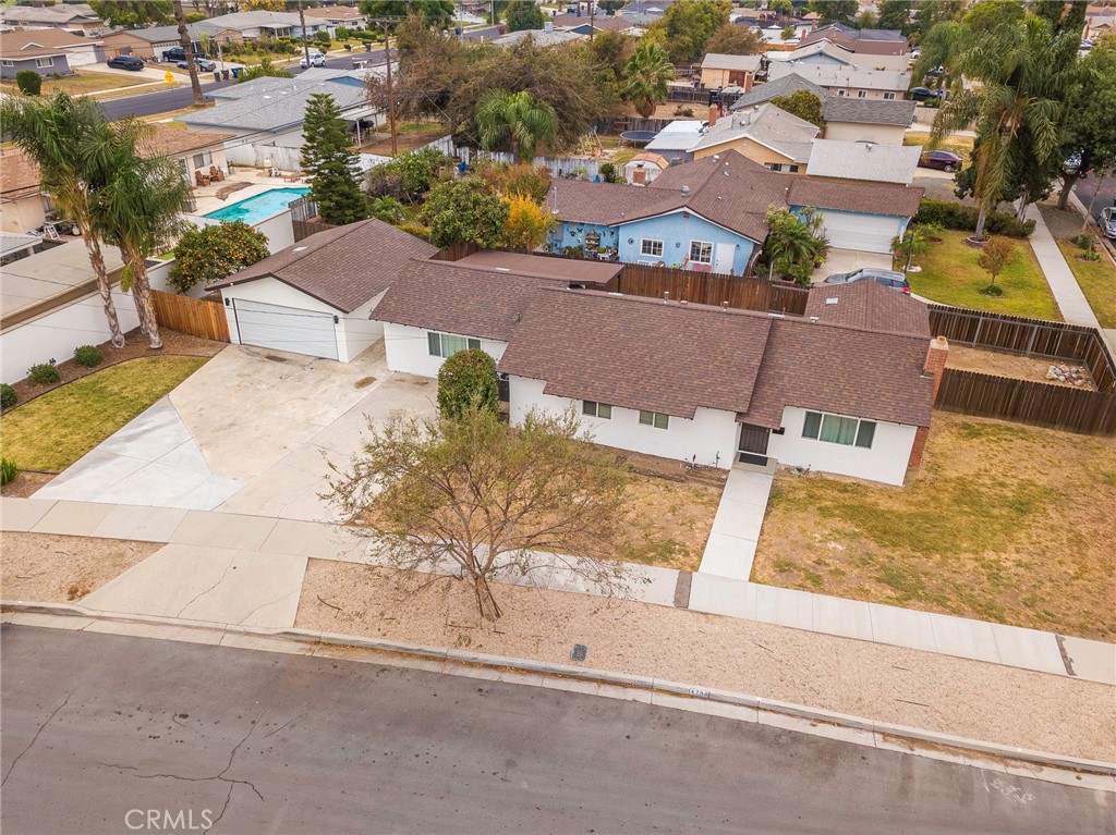 an aerial view of residential houses with yard