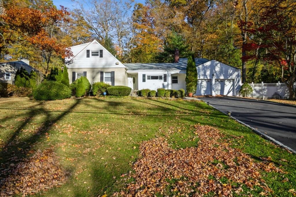 View of front of property with a garage and a front lawn