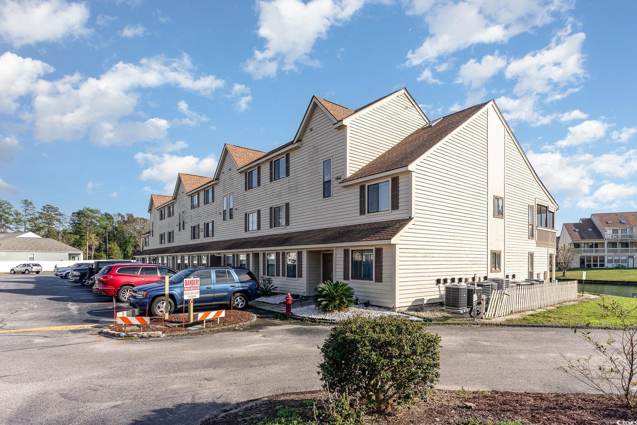 View of front of home with central AC