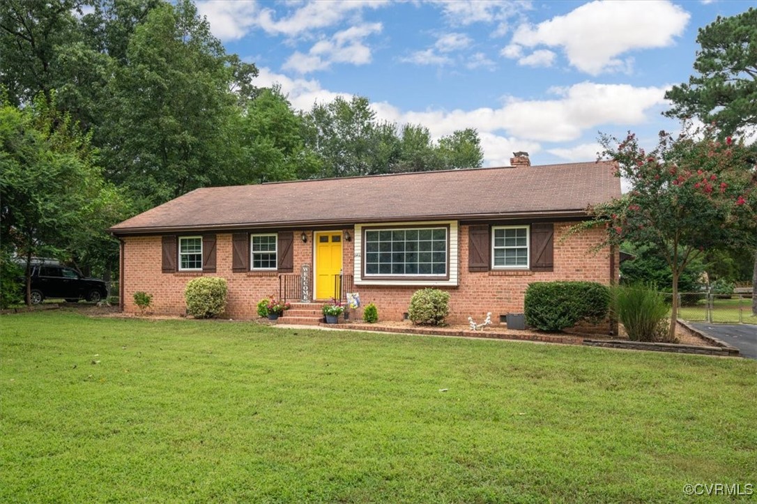 a front view of a house with a yard and trees