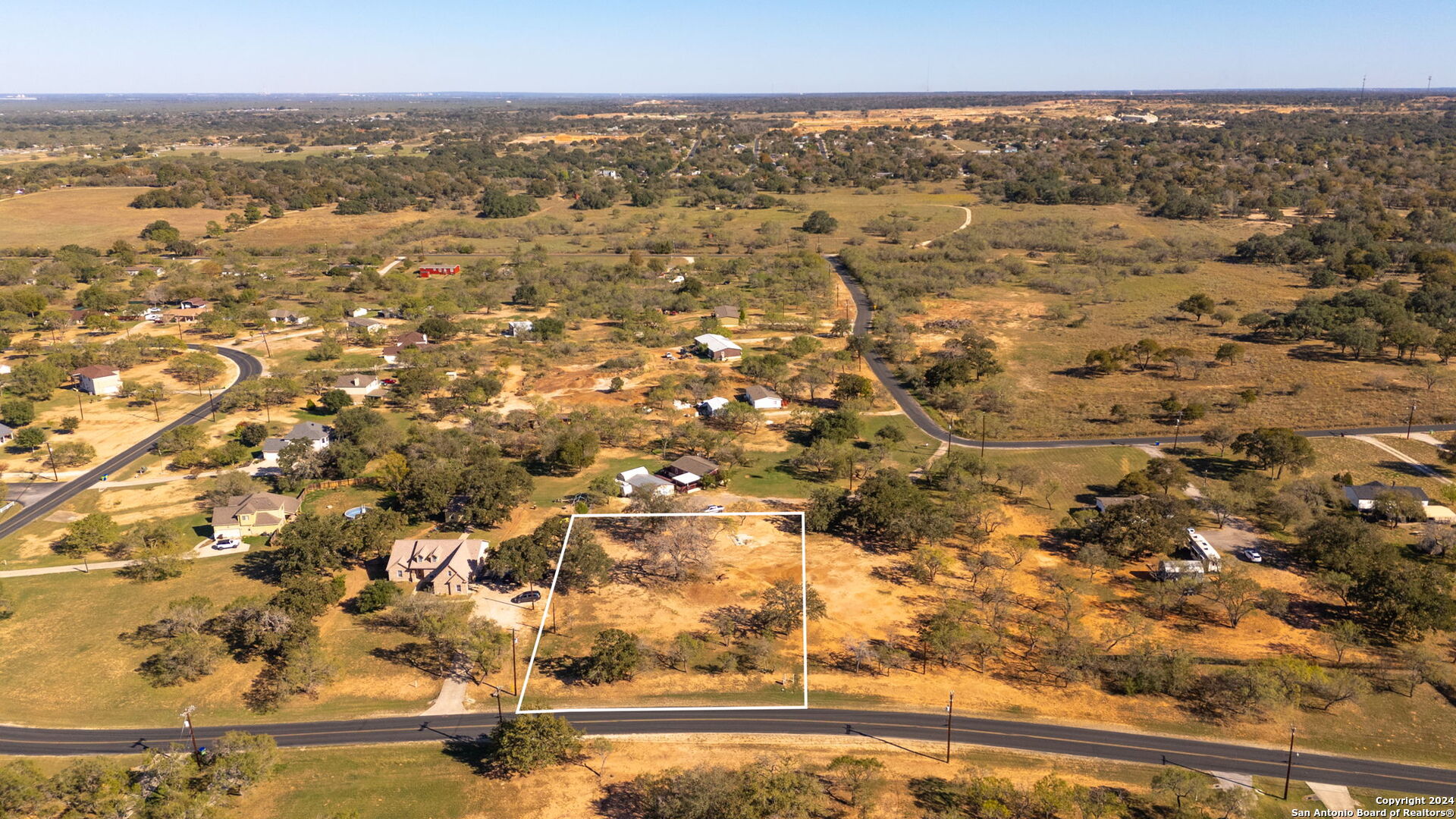 an aerial view of residential houses with outdoor space