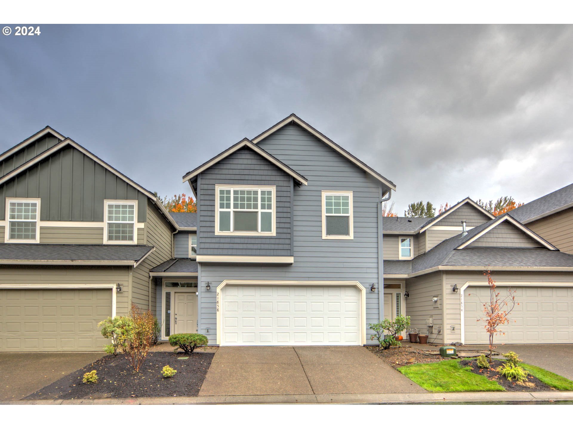 a front view of a house with a yard and garage