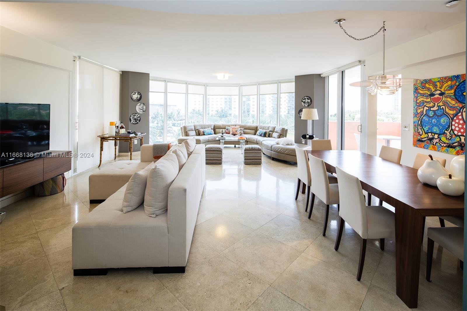 a living room with furniture dining table and a flat screen tv