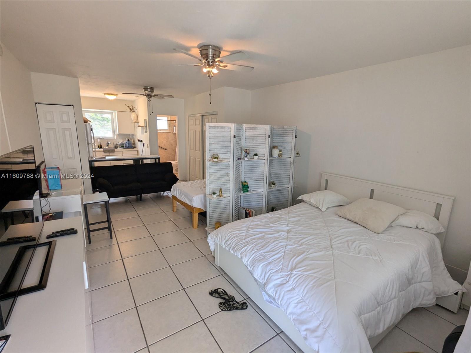 a large bedroom with a bed furniture and a window