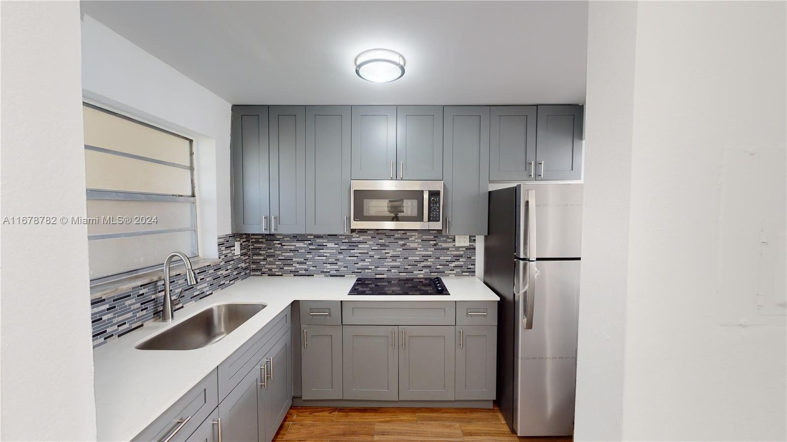 a kitchen with a refrigerator sink and stove