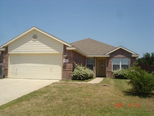 a view of a house with a yard and plants