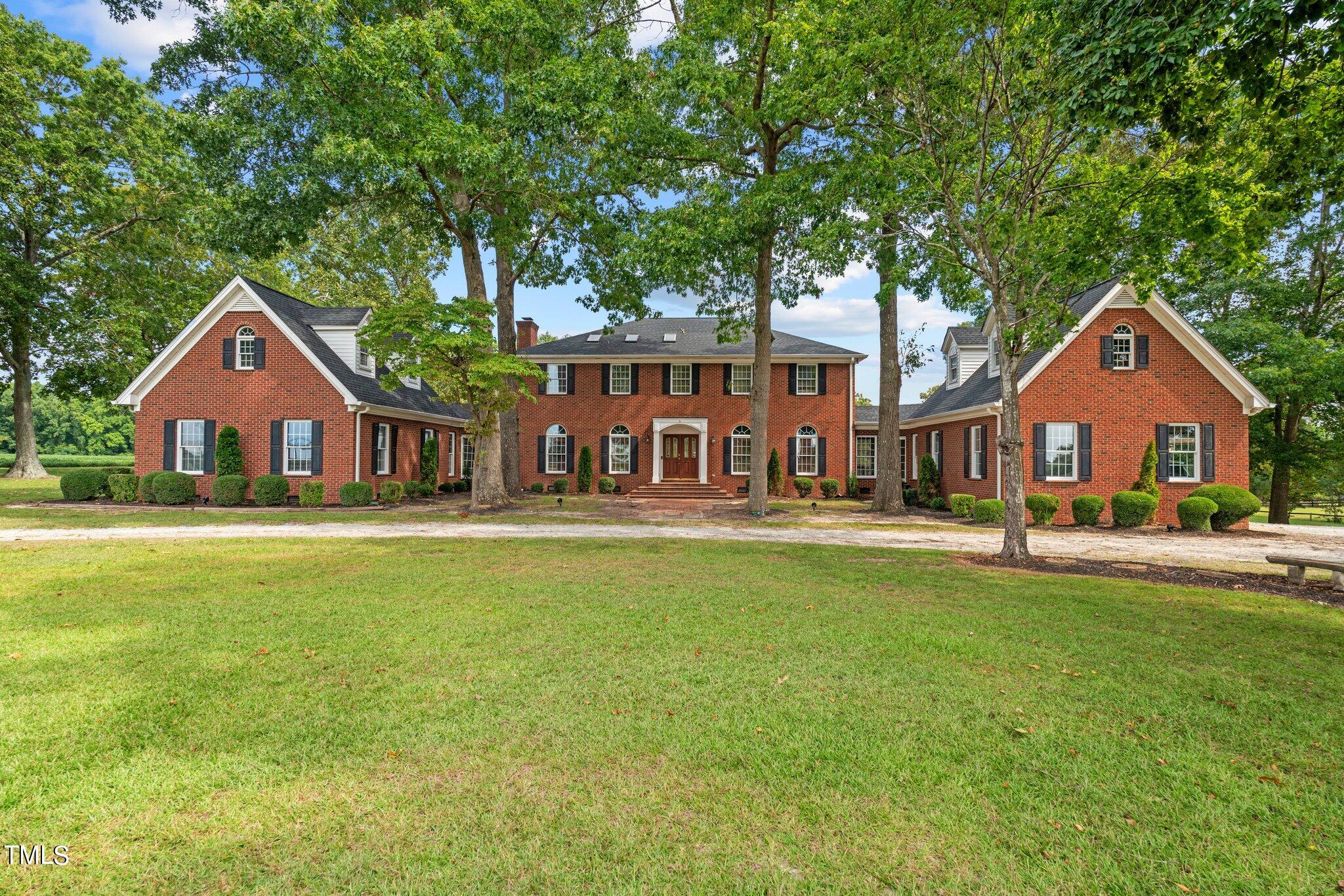 a front view of a house with swimming pool having outdoor seating