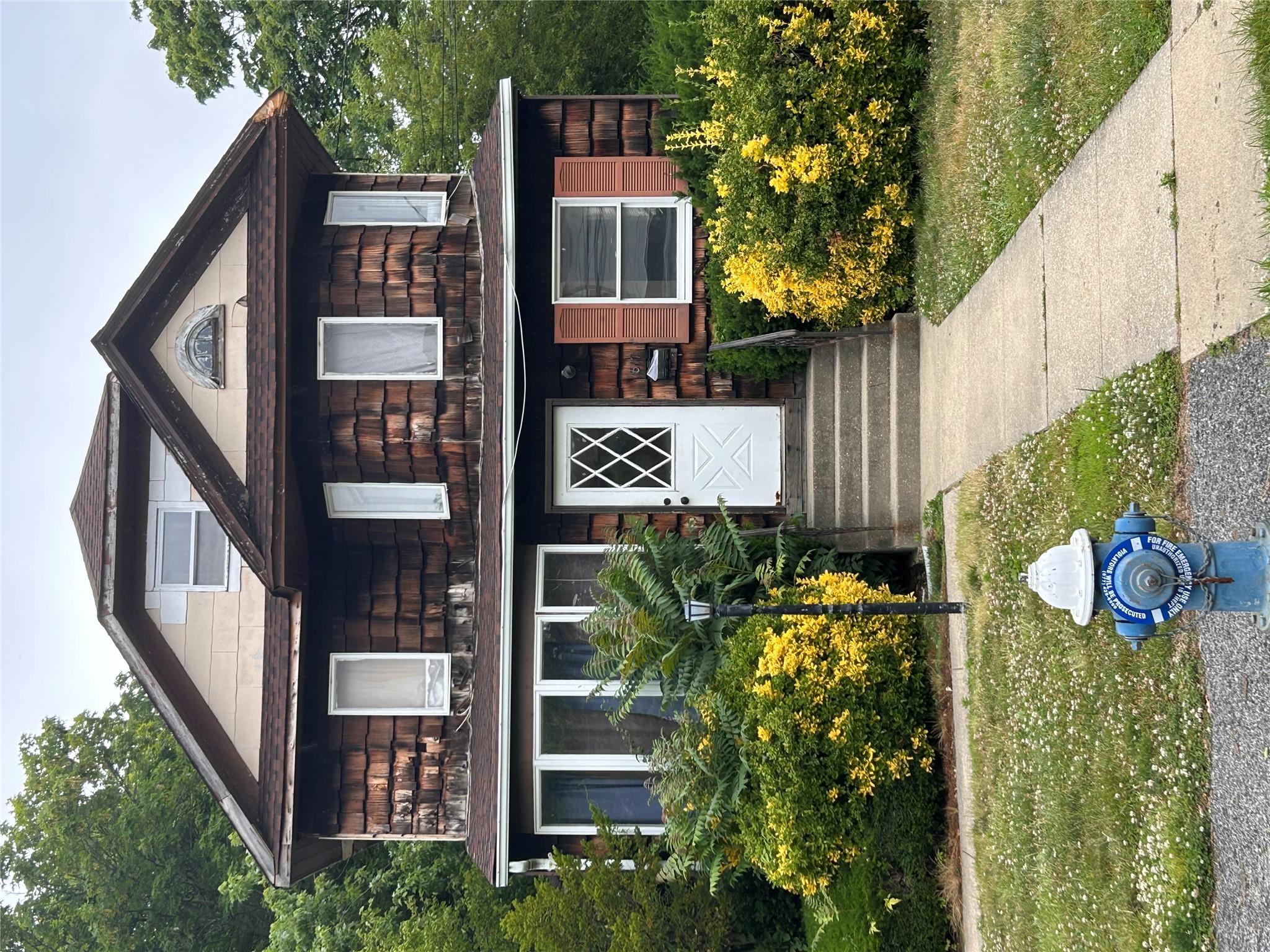 a front view of a house with garden