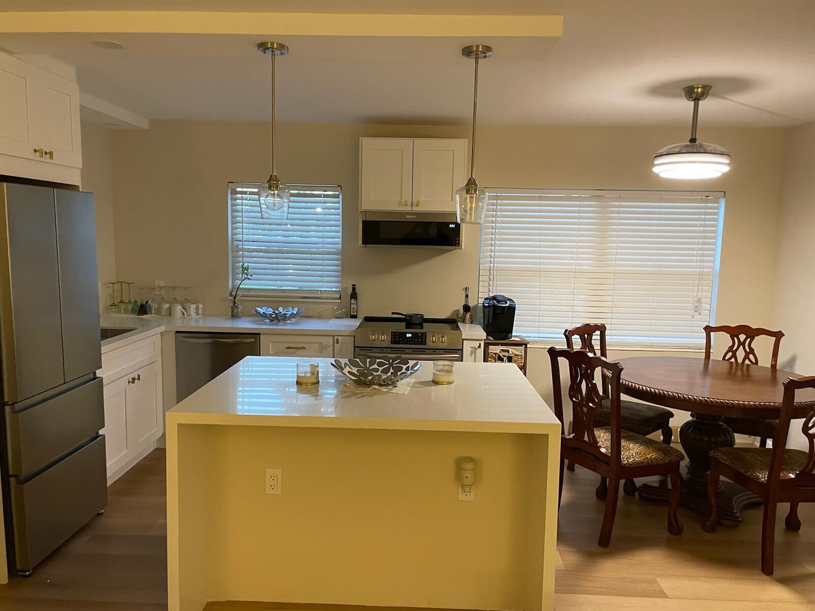 a kitchen with a sink a stove a dining table and chairs