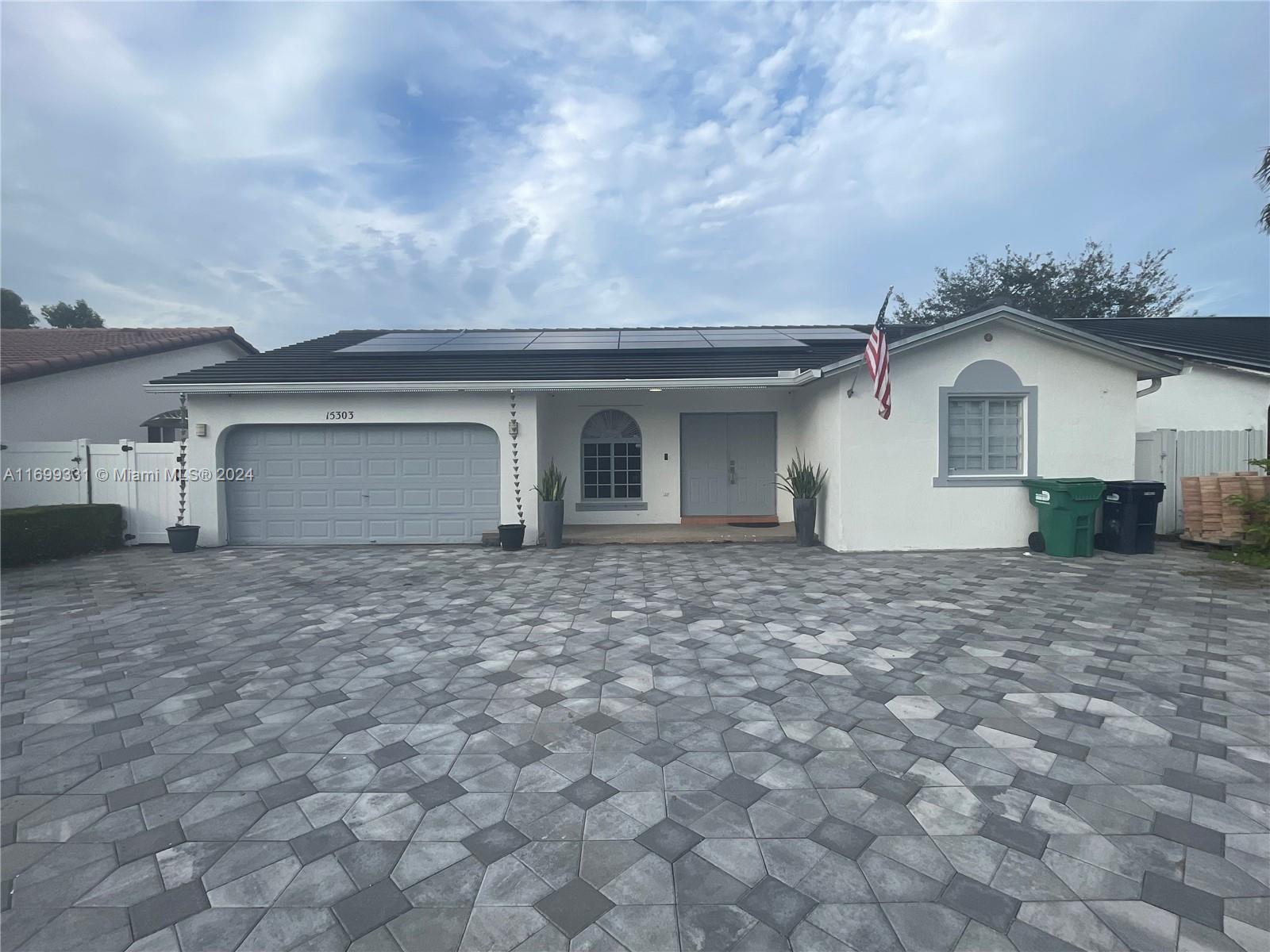 a view of a house with a yard and garage