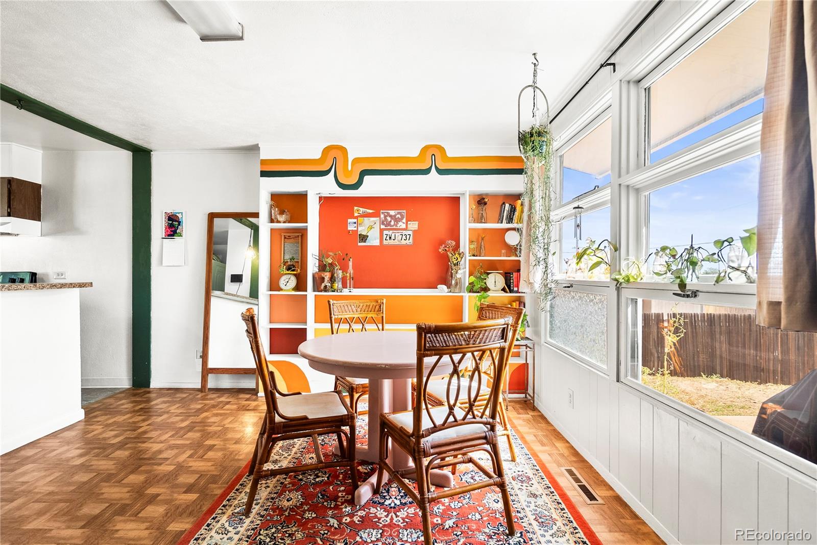 a dining room with furniture and a floor to ceiling window