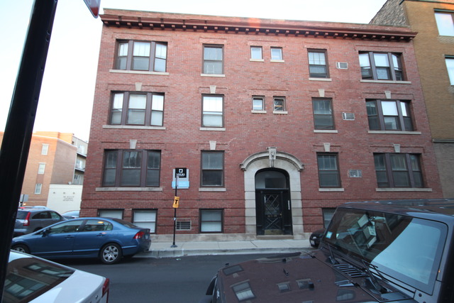 a front view of a building with parking space