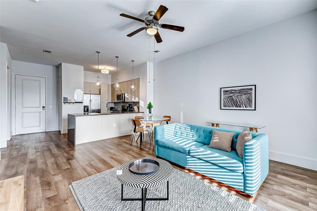 a living room with furniture and kitchen view