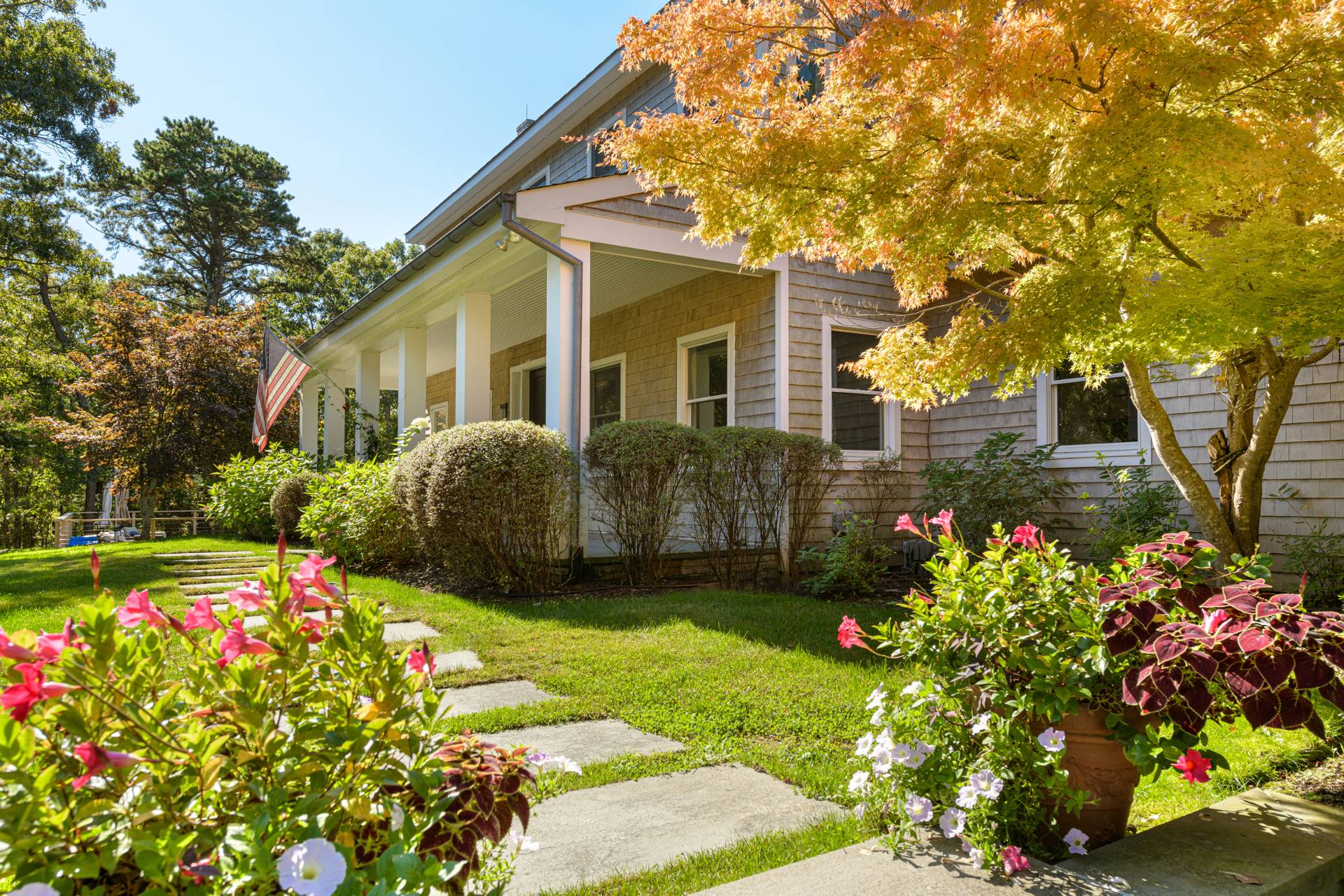 a front view of a house with a yard and fountain