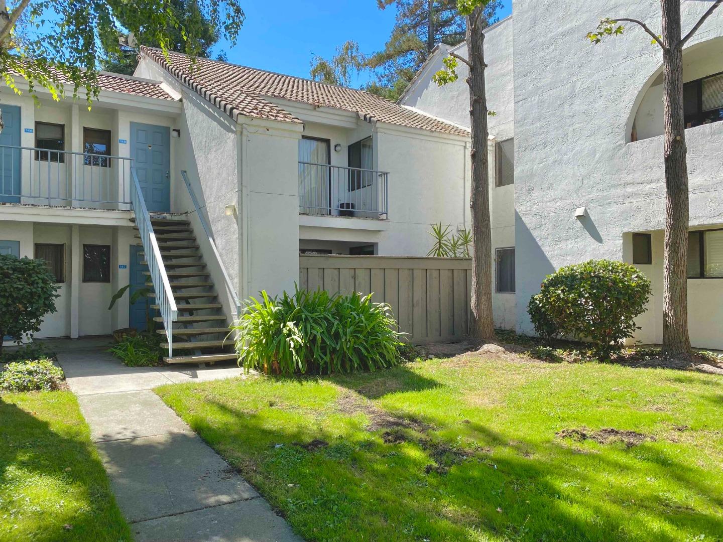 a view of a house with a yard and plants