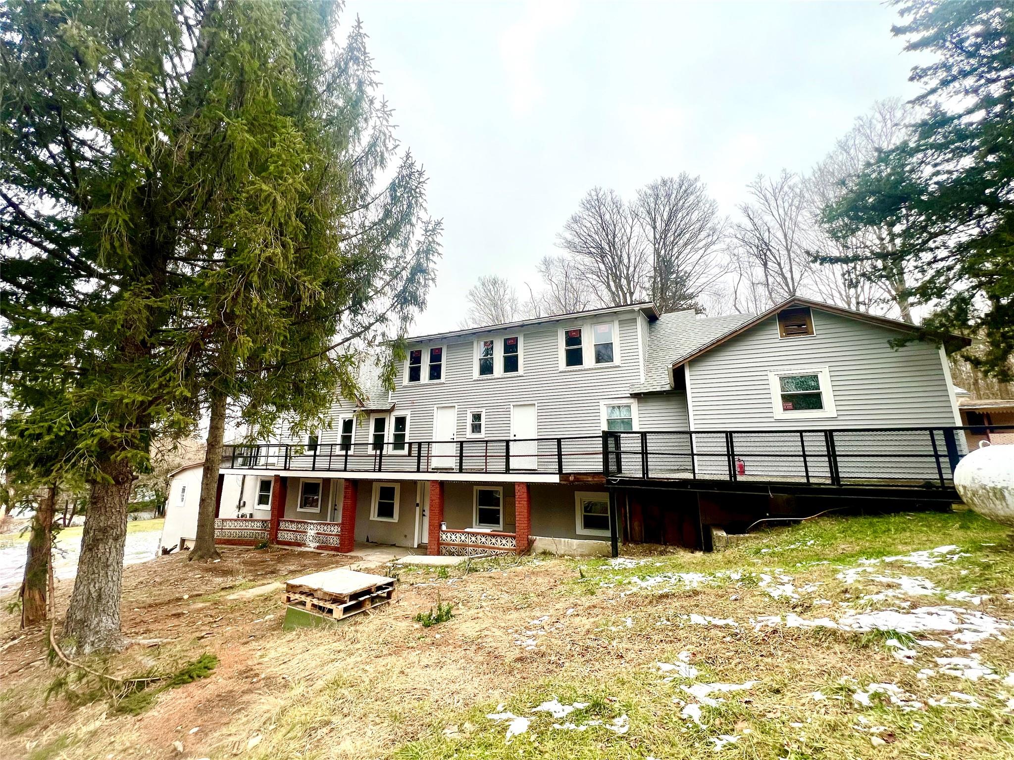 a view of a house with a wooden deck