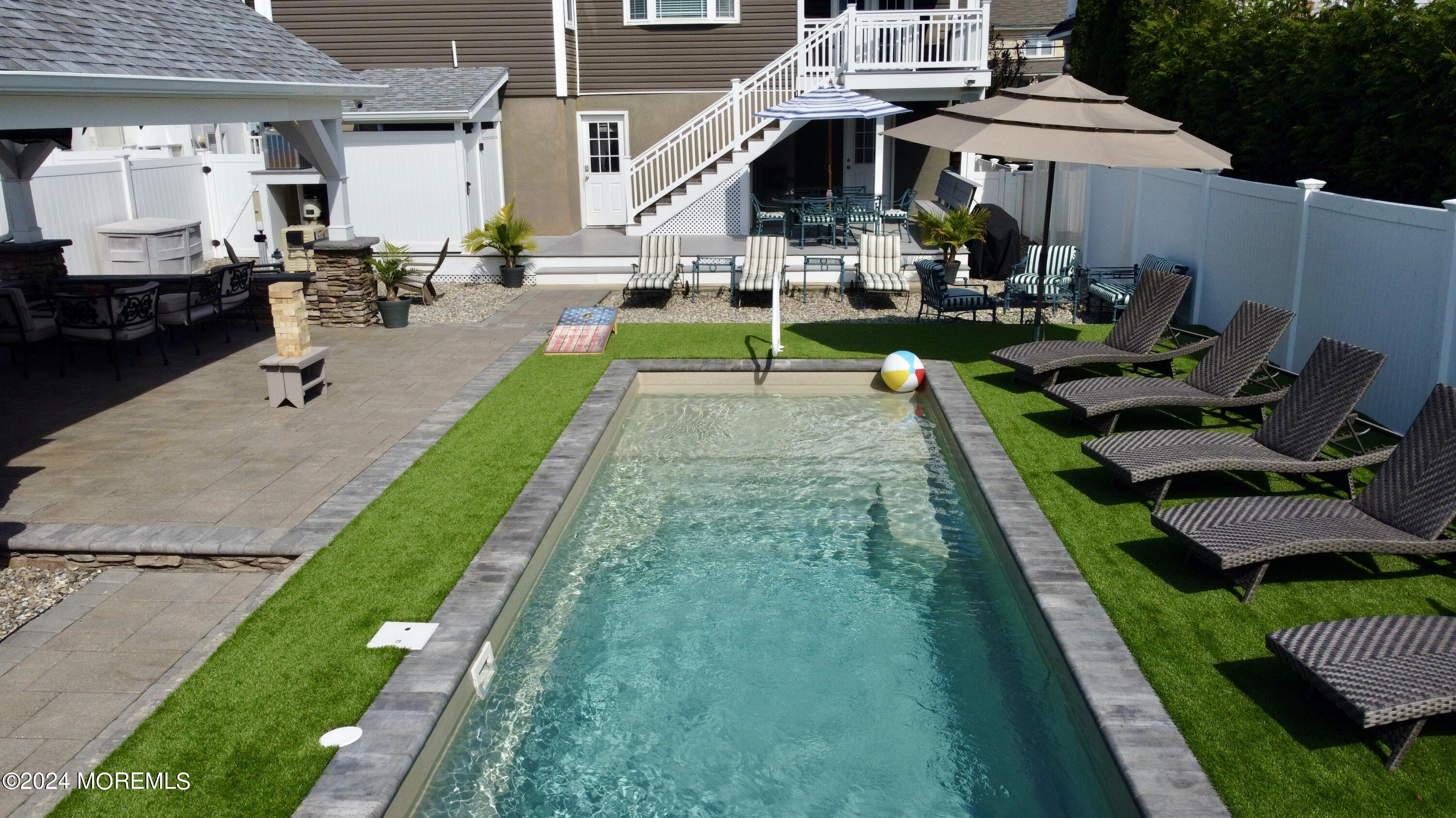 a view of a house with backyard porch and sitting area