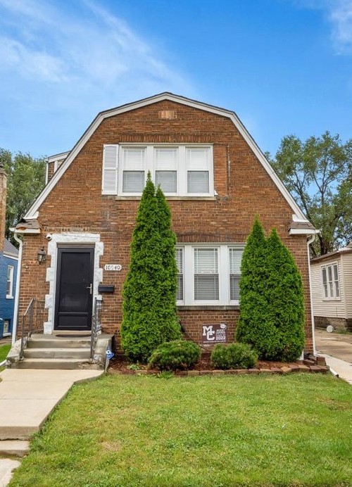 a front view of a house with a yard