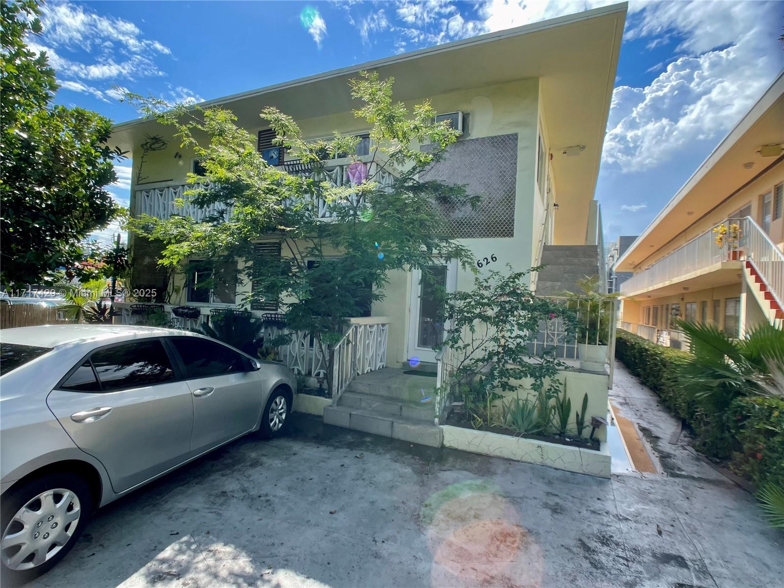 a view of a car parked front of a house