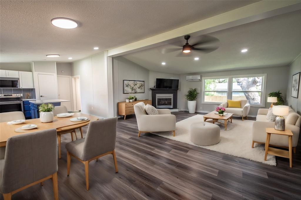 a living room with fireplace furniture and a wooden floor