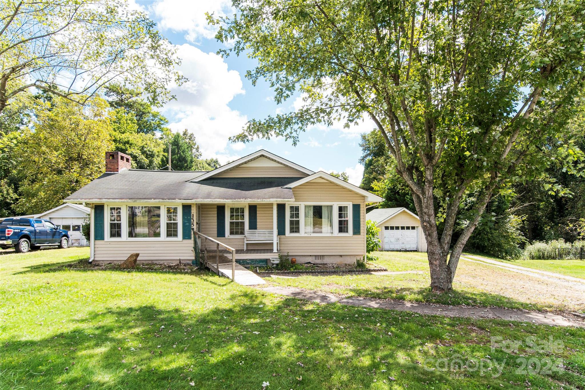 a front view of a house with yard and green space