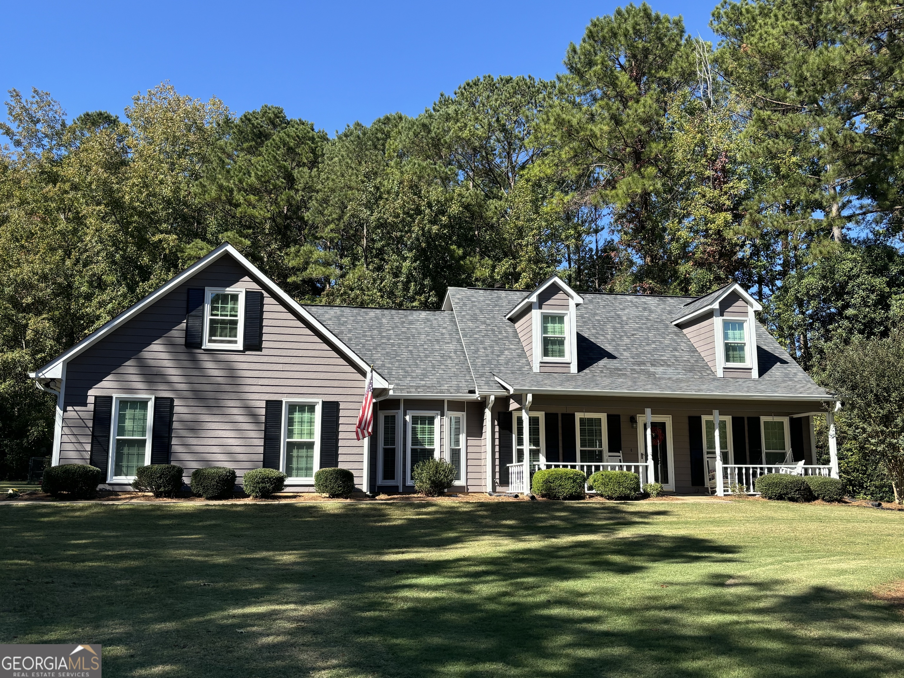 a front view of a house with a garden