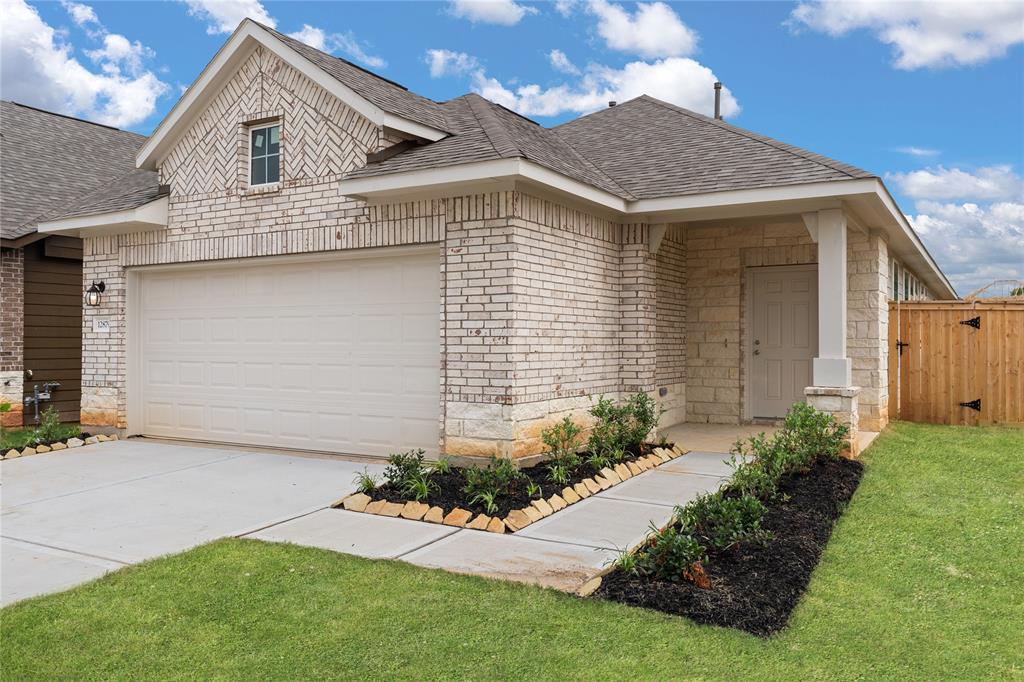 a front view of a house with a garden and plants