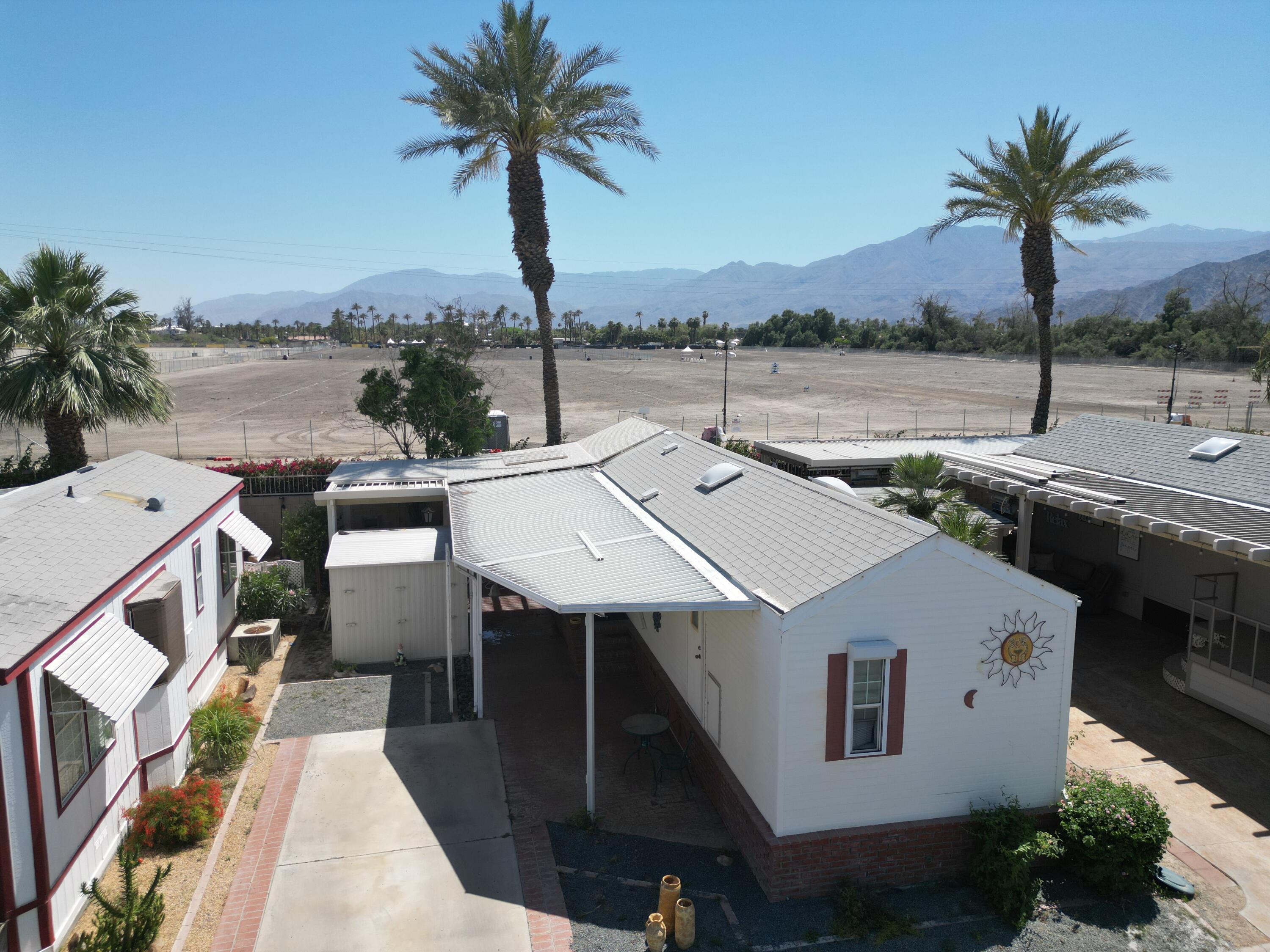 an aerial view of a house with outdoor space and ocean view