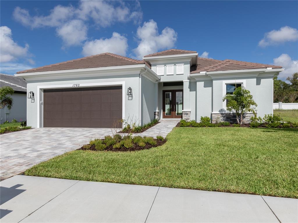 a front view of a house with a yard and garage